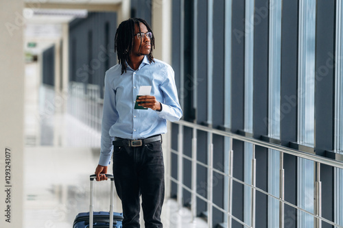 Male tourist is in the airport corridor photo