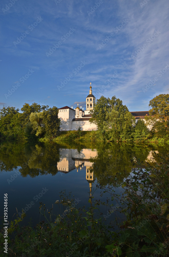 View of the St. Paphnutiev Borovsky Monastery from the ponds in summer. Russia, Kaluga region. Orthodox monastery. View of the St. Paphnutiev Borovsky Monastery from the ponds in summer. Russia, Kaluga region. Orthodox monastery.