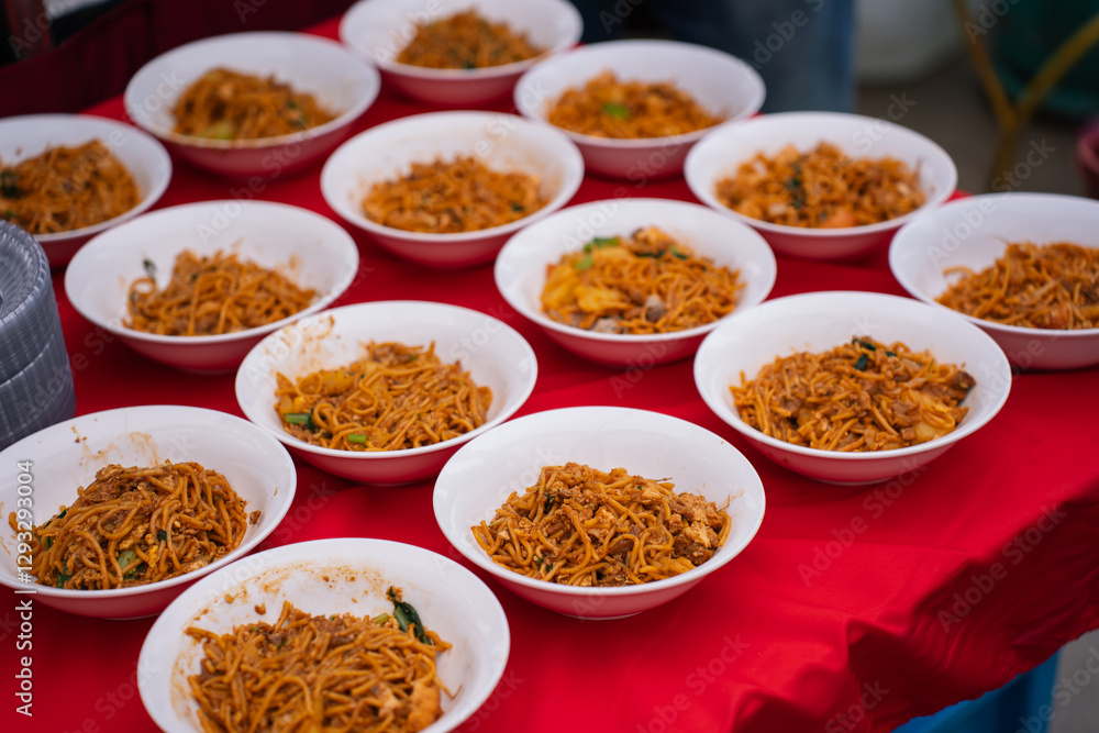 Fried noodles prepared in white bowls serving at the buffet. Fried noodles prepared in white bowls serving at the buffet.