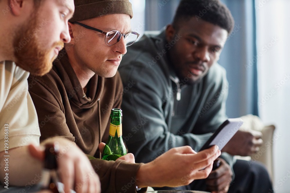 Side view portrait of three sports fans looking at smartphone screen intensely while watching game online Side view portrait of three sports fans looking at smartphone screen intensely while watching game online