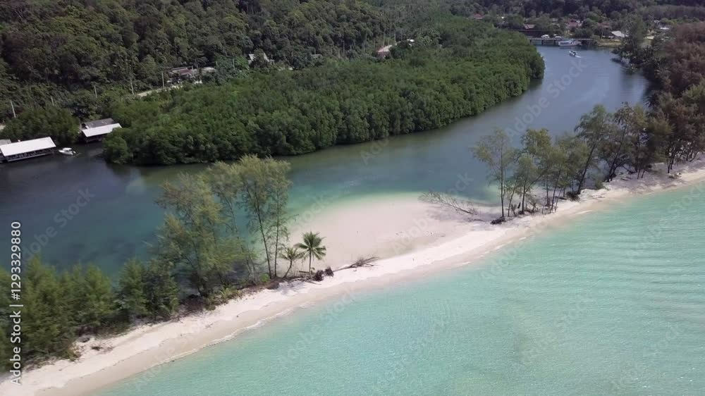 Aerial view of Klong Chao Beach,backwards slowly,one side river one side sea divided by white sand beach surrounded by lush greenery. Aerial view of Klong Chao Beach,backwards slowly,one side river one side sea divided by white sand beach surrounded by lush greenery.