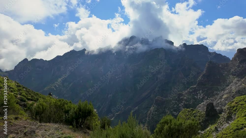 Dynamic Timelapse from PR1.1 Mountain Trail with Tall Mountain Peaks and Moving White Clouds, Madeira Island. Dynamic Timelapse from PR1.1 Mountain Trail with Tall Mountain Peaks and Moving White Clouds, Madeira Island.