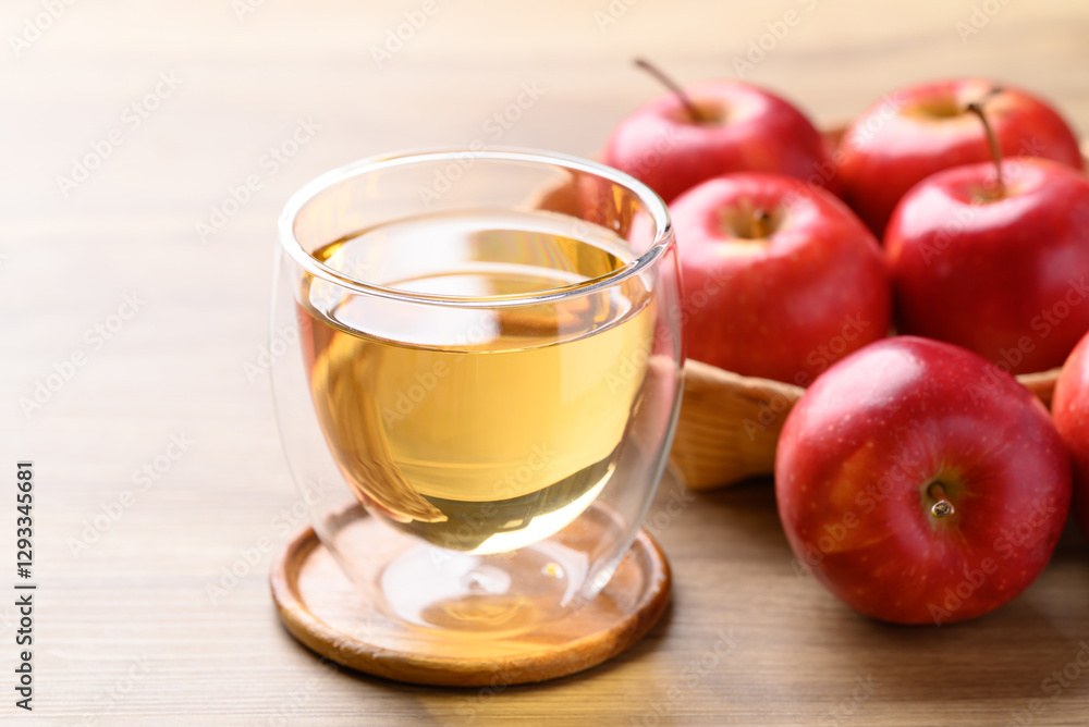 Glass of apple cider and red apple fruit on wooden background Glass of apple cider and red apple fruit on wooden background