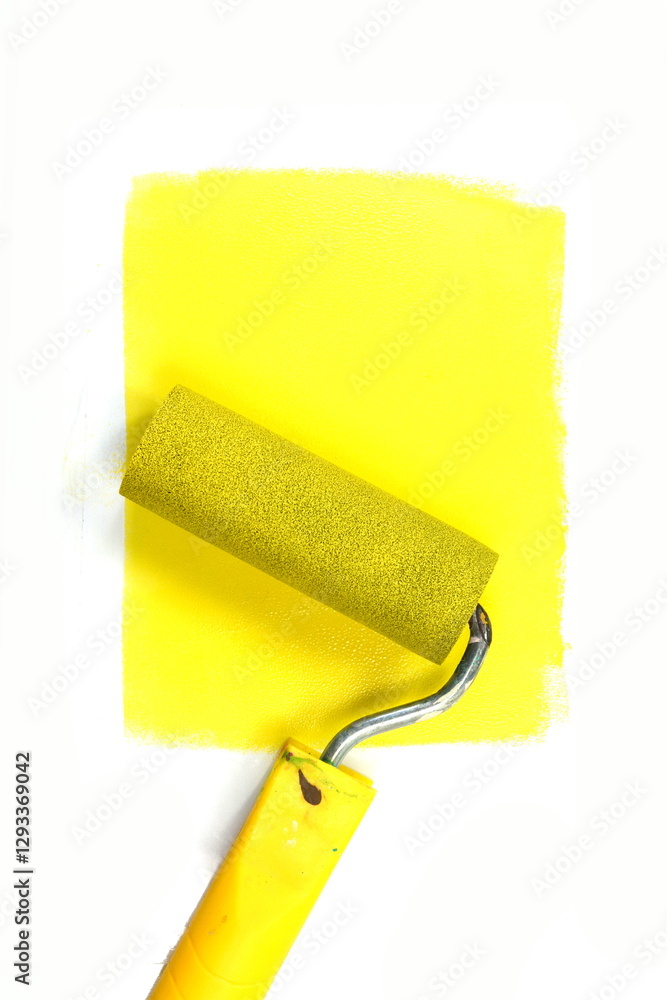 Obraz premium Painting a rough wall with roller. Paint roller leaving stroke of yellow color over a white background. usable for text and messages.