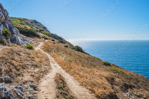 Cliff trail pathway next to the blue sea at Cabo Espichel, Sesimbra PORTUGAL