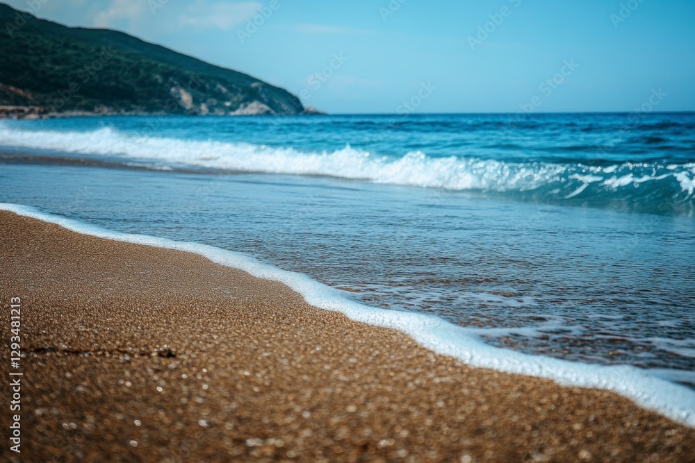 Serene beach scene with gentle waves lapping onto the sandy shore in a scenic coastal landscape Serene beach scene with gentle waves lapping onto the sandy shore in a scenic coastal landscape