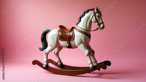 Vintage rocking horse with a charming design on a soft pink background ideal for children's decor and nostalgic themes. photo