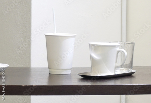 White cup and paper glass on wooden table, Modern style