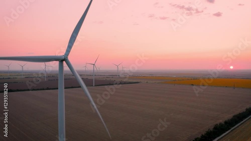 Wind turbines on coastline at sunset, aerial view
