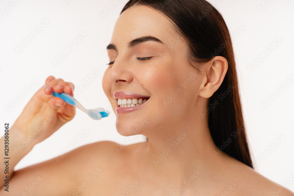 Close-up image of a smiling person practicing oral hygiene while brushing teeth with a toothbrush. The bright setting and joyful expression emphasize health, cleanliness, and personal care. Close-up image of a smiling person practicing oral hygiene while brushing teeth with a toothbrush. The bright setting and joyful expression emphasize health, cleanliness, and personal care.