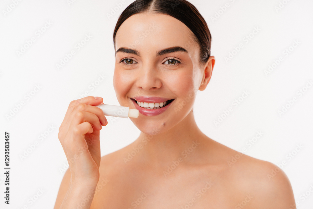 Close-up of an individual applying lip balm to moisturize lips, promoting skincare and natural beauty. Emphasizes self-care and serenity, reflecting an effortless and radiant appearance. Close-up of an individual applying lip balm to moisturize lips, promoting skincare and natural beauty. Emphasizes self-care and serenity, reflecting an effortless and radiant appearance.