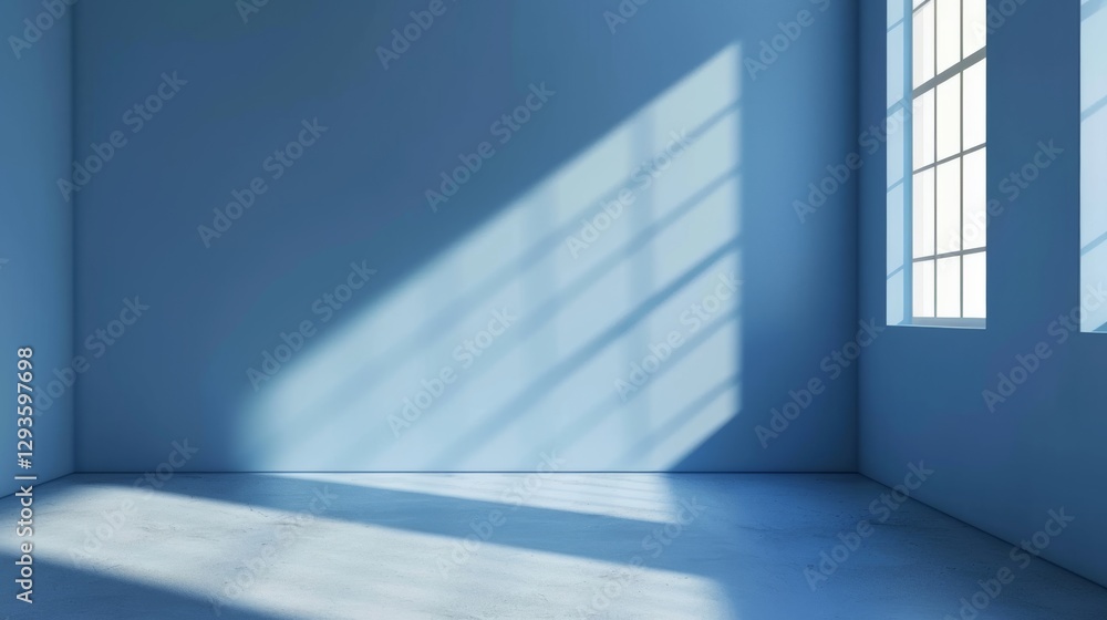 Fototapeta premium Sunlight casts geometric window shadows on a blue wall and floor in an empty minimalist room. The soft lighting and cool tones create a tranquil, modern atmosphere