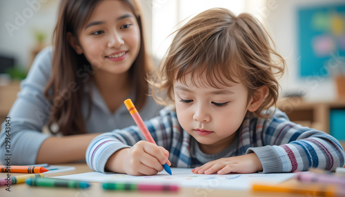 Wallpaper Mural Young child focused on coloring a picture with vibrant crayons while an attentive adult watches lovingly, fostering creativity and learning Torontodigital.ca