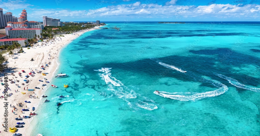Aerial view of the public beach at Goodmans Bay, Nassau, Bahamas, with water sports and turquoise ocean