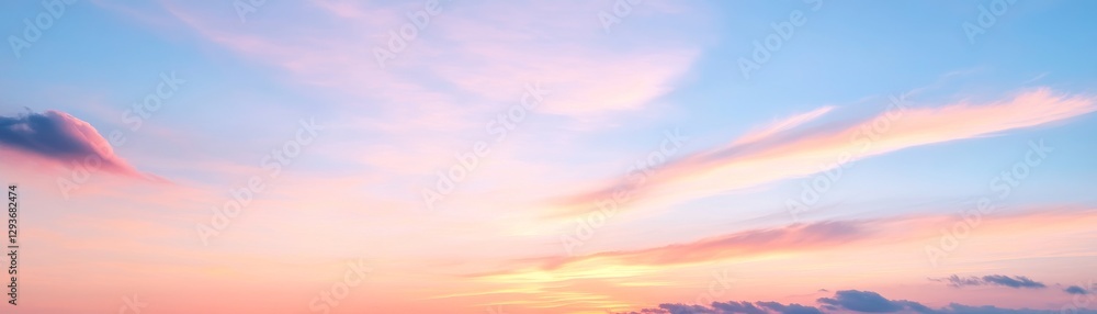Obraz premium Sunset-dappled clouds with warm pastel sky, peaceful dreamscape.