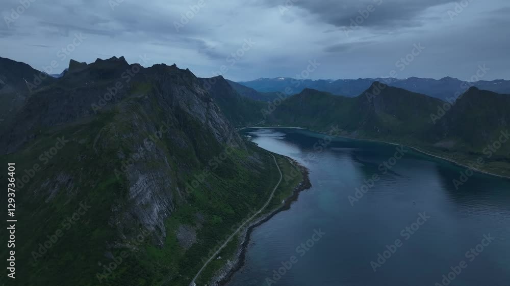 Drone view of dramatic sunset on ocean and coastal mountains on Senja island, Norway Drone view of dramatic sunset on ocean and coastal mountains on Senja island, Norway