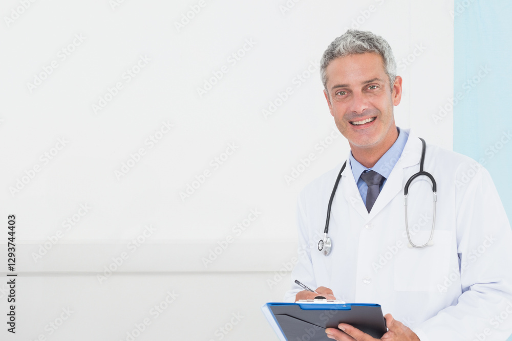 Doctor smiling with clipboard in office, wearing stethoscope and white coat, copy space Doctor smiling with clipboard in office, wearing stethoscope and white coat, copy space