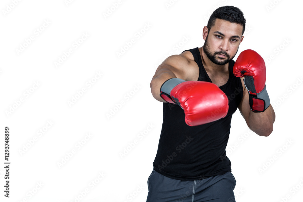 Boxer in red gloves throwing punch, focused and determined in studio, copy space Boxer in red gloves throwing punch, focused and determined in studio, copy space