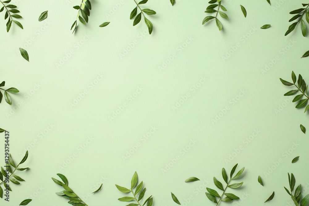Green leaves frame on a light green background. Flat lay, top view, copy space Green leaves frame on a light green background. Flat lay, top view, copy space