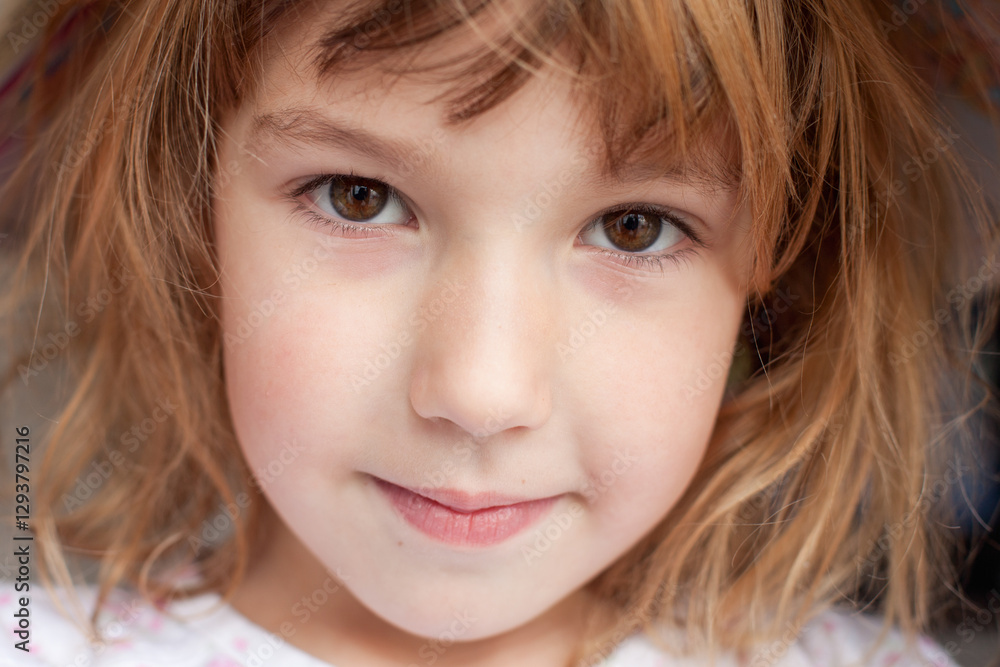 closeup portrait of face of little girl looking at camera smiling closeup portrait of face of little girl looking at camera smiling