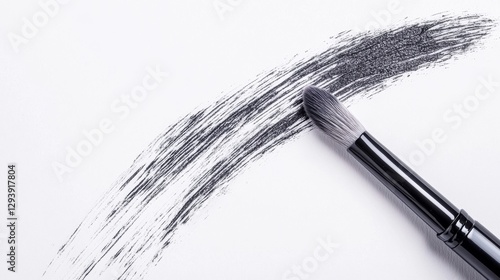 Brush creating a stroke on white paper surface