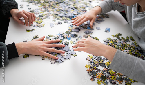 Принти на полотні Girls Putting Puzzle Pieces Together On The Table A Hobby For The Whole Family