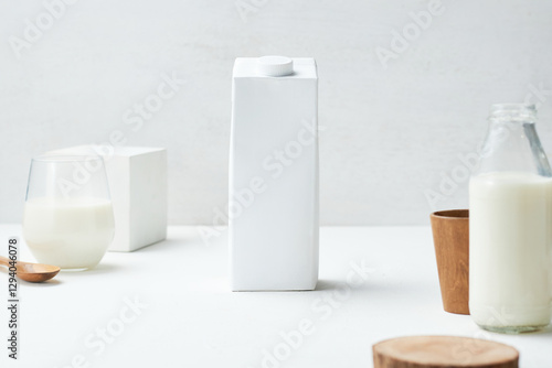 Milk Carton Positioned Centrally on a Minimalistic Table With Various Containers, Creating a Clean and Modern Kitchen Atmosphere