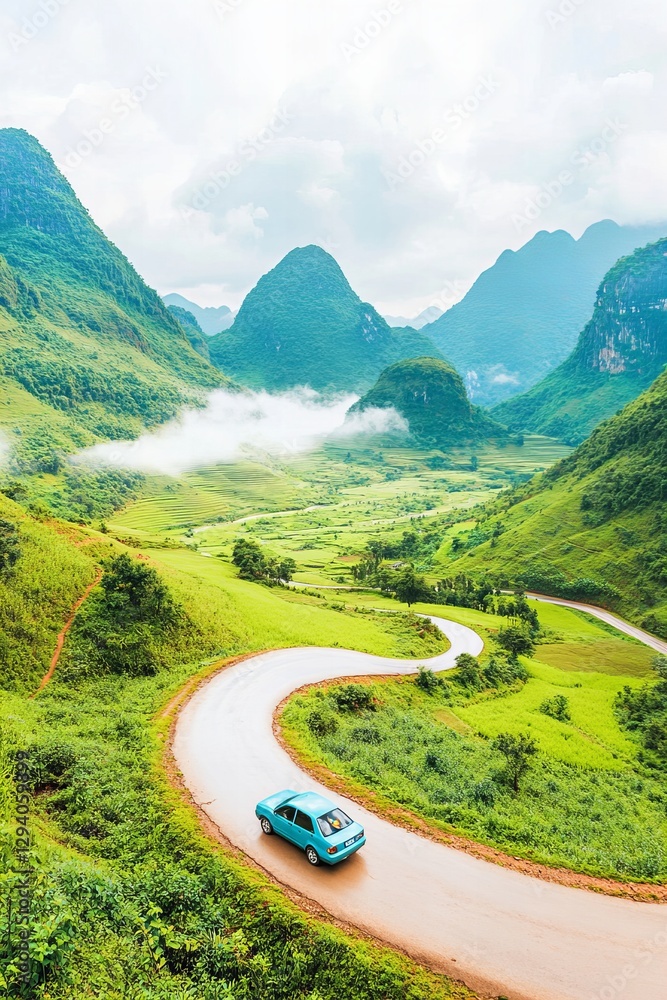 Fototapeta premium Vintage car on scenic winding road through lush green mountains on cloudy day