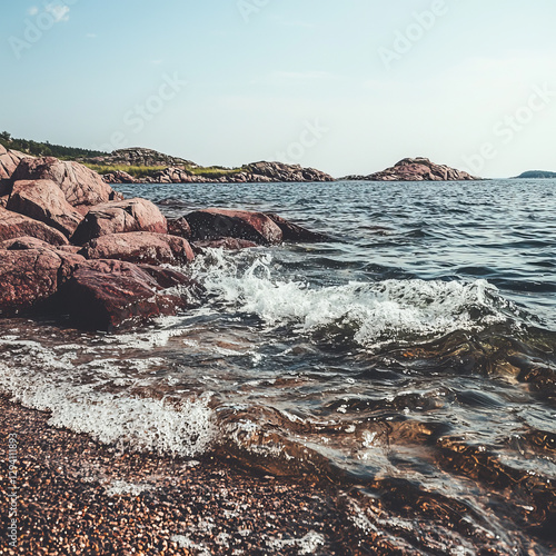 Rocky shore waves gently lapping  Tranquil coastal scene photo