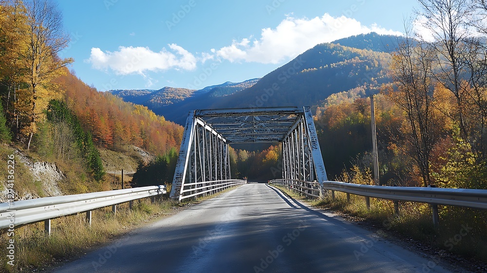 Obraz premium Modern steel bridge on a mountain road on a clear fall day