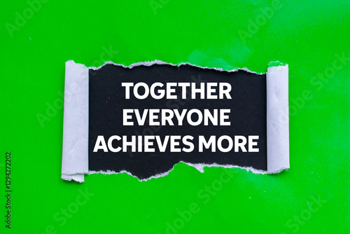 Φωτογραφία Together everyone achieves more message written on ripped torn green paper on black background