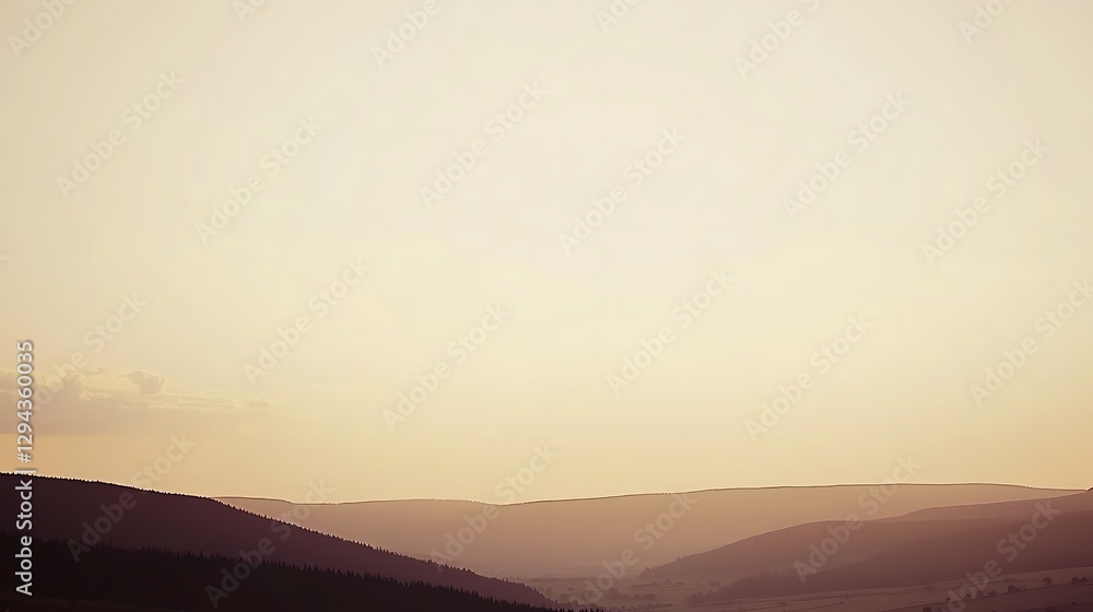 Obraz premium A breathtaking golden sky at sunrise, with warm hues of orange and gold illuminating a peaceful, calm landscape below.