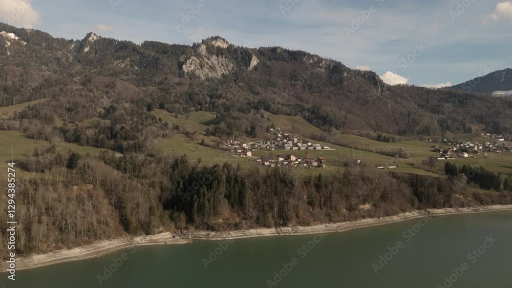 custom made wallpaper toronto digitalScenic view of a Swiss village near a lake, surrounded by mountains and forests. Green fields, rural houses, peaceful landscape, nature, tourism, travel, Switzerland, Alps, countryside, aerial view