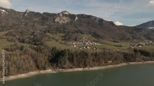 Wallpaper Mural Scenic view of a Swiss village near a lake, surrounded by mountains and forests. Green fields, rural houses, peaceful landscape, nature, tourism, travel, Switzerland, Alps, countryside, aerial view Torontodigital.ca