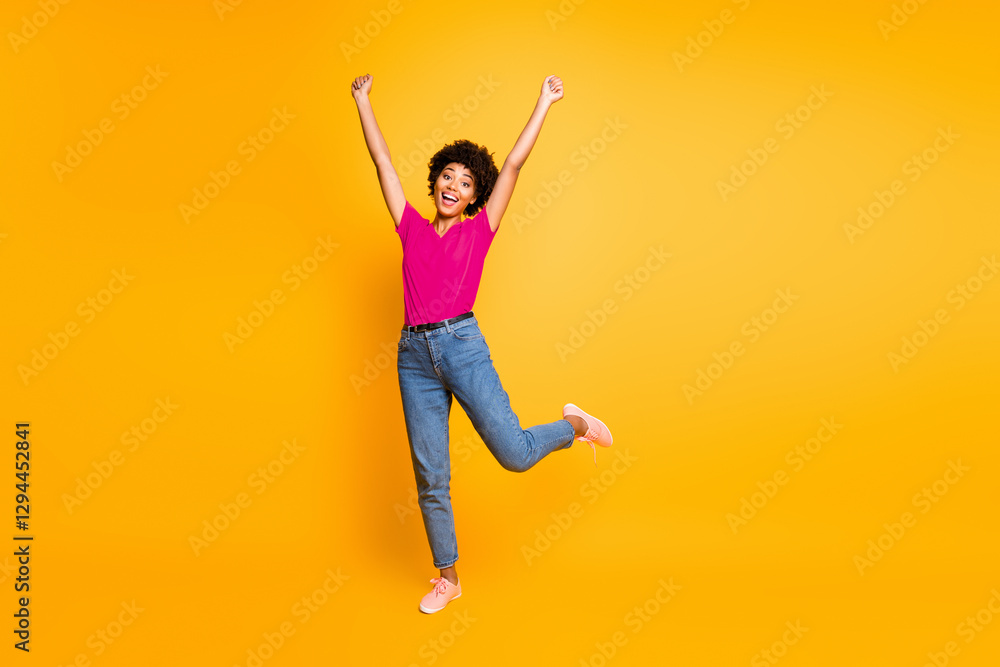 Full length body size photo of cheerful charming cute nice student rejoicing with victory she obtained wearing jeans denim orange t-shirt footwear isolated over yellow vivid color background Full length body size photo of cheerful charming cute nice student rejoicing with victory she obtained wearing jeans denim orange t-shirt footwear isolated over yellow vivid color background