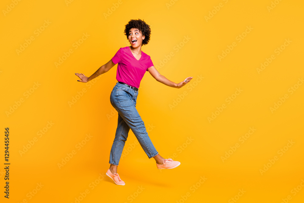 Full length body size photo of charming cute cheerful wavy curly sweet attractive black girlfriend wearing t-shirt jeans denim going side profile to you isolated over yellow vivid color background Full length body size photo of charming cute cheerful wavy curly sweet attractive black girlfriend wearing t-shirt jeans denim going side profile to you isolated over yellow vivid color background