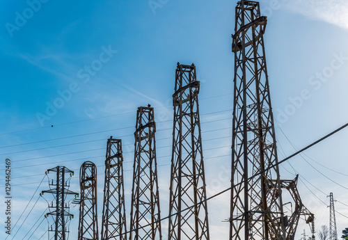 pillar of power electric line support on blue sky background. Electric energy industrial concept