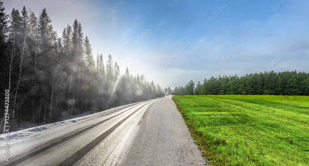 Fototapeta premium Wechsel von Winterfahrbahn zu sommerfahrbahn auf einer Landstrasse