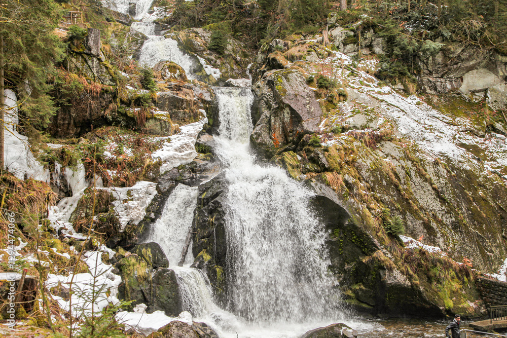 A waterfall in Triberg Germany black forest is flowing into a river A waterfall in Triberg Germany black forest is flowing into a river