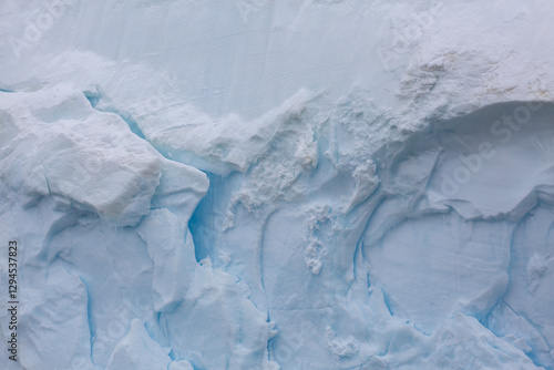 Abstract closeup of details and textures of ice from the wall of an iceberg in Antarctica
