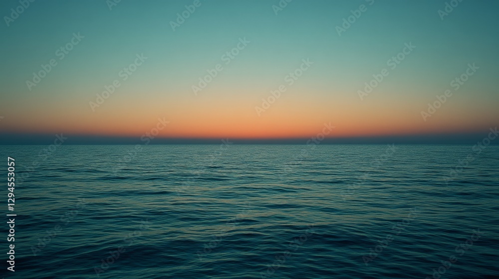 Fototapeta premium A mesmerizing seascape at sunset, where the sun's glow transitions into deep blue, stretching across the horizon, embodying peace and infinity.