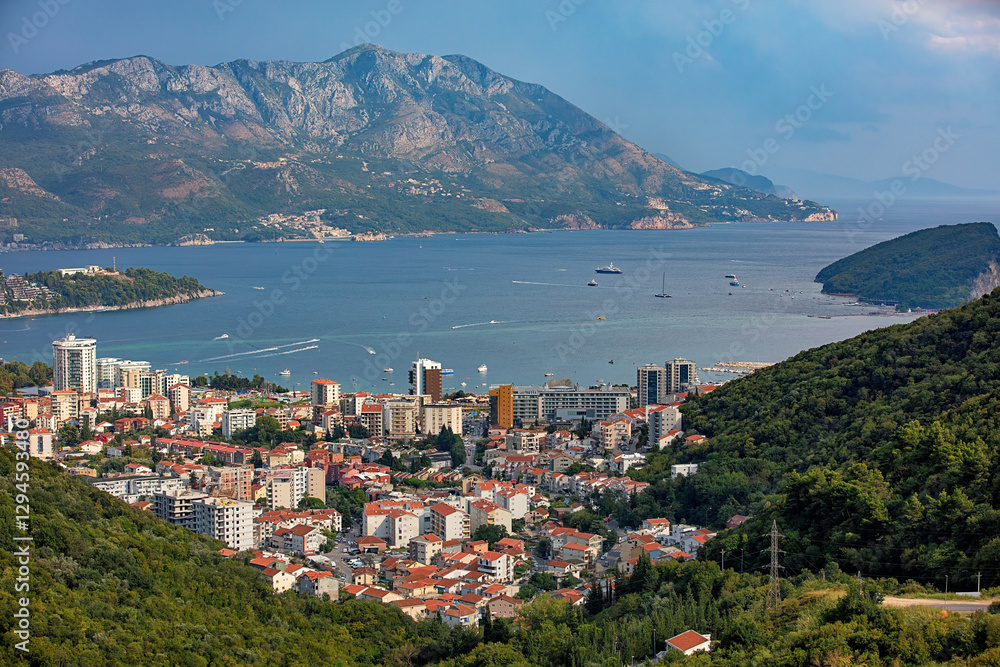 A stunning coastal view of a bay surrounded by mountains in the bustling seaside town of Budva.