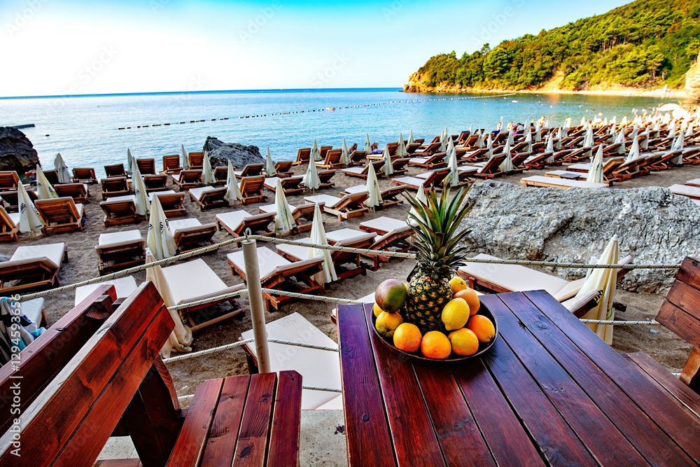 Relaxing beachside retreat offers stunning views and fresh fruit delights at a tropical paradise
