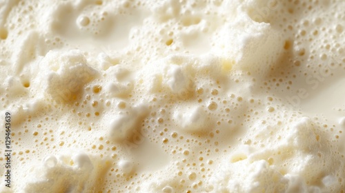 Creamy dairy surface with frothy, clustered bubbles forming intricate texture, highlighting delectable dairy product's visual richness