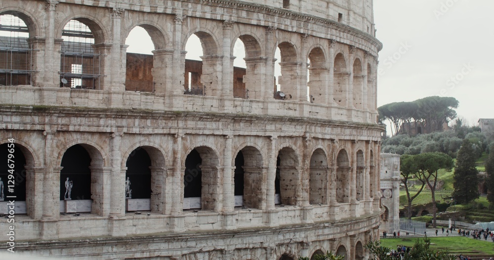Fototapeta premium Close-up of part of the Coliseum on a sunny warm day. Italy tourist attraction, Rome. Many tourists at the foot of the monument of architecture. Video in 4k, red komodo