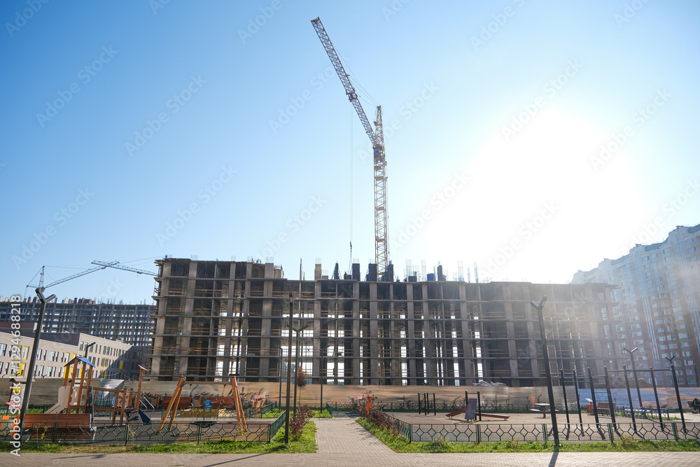 Construction site with cranes on blue sky background Construction site with cranes on blue sky background