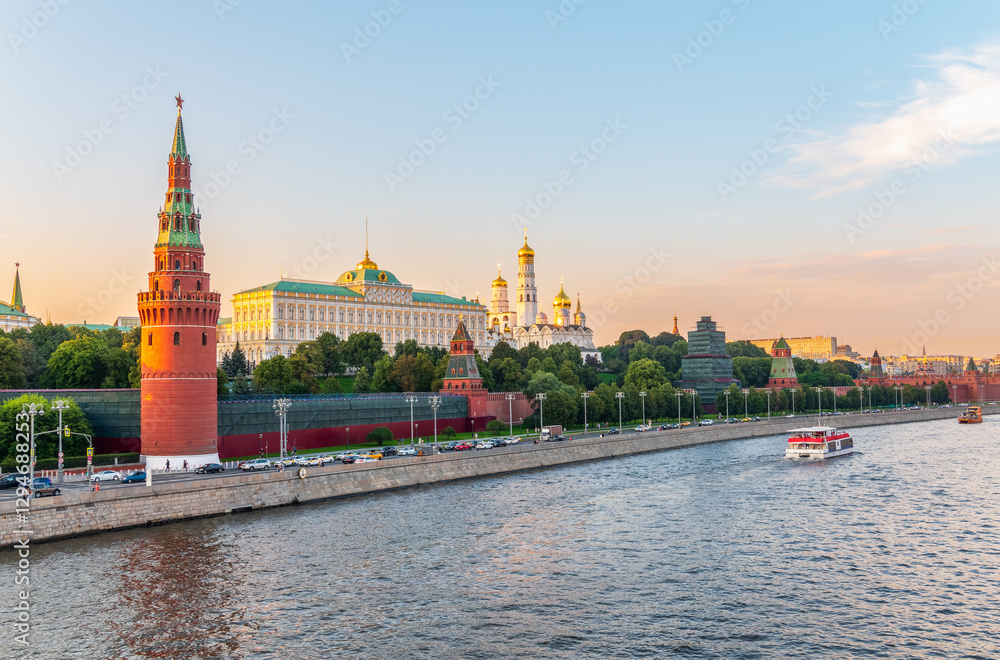View of Kremlin with Vodovzvodnaya tower, Grand Kremlin Palace from repaired Bolshoy Kamenny Bridge in Moscow city on sunny summer day. Cruise ship sails on the Moscow river View of Kremlin with Vodovzvodnaya tower, Grand Kremlin Palace from repaired Bolshoy Kamenny Bridge in Moscow city on sunny summer day. Cruise ship sails on the Moscow river