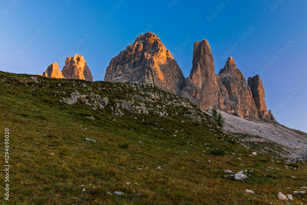 Tre Cime di Lavaredo during sunrise with warm golden light
