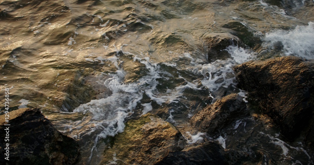 Sea water with foam waves hits the coastal rocks, splashing beautifully and washing the boulders. 4k video, red komodo Sea water with foam waves hits the coastal rocks, splashing beautifully and washing the boulders. 4k video, red komodo