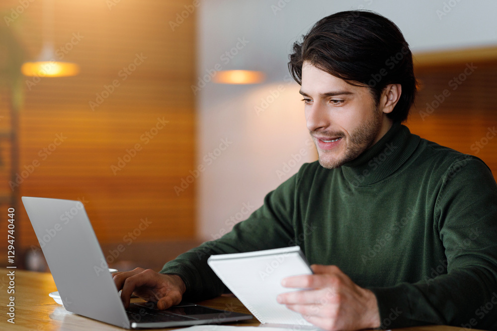 Famous male blogger working on new article, using laptop at cafe, empty space Famous male blogger working on new article, using laptop at cafe, empty space